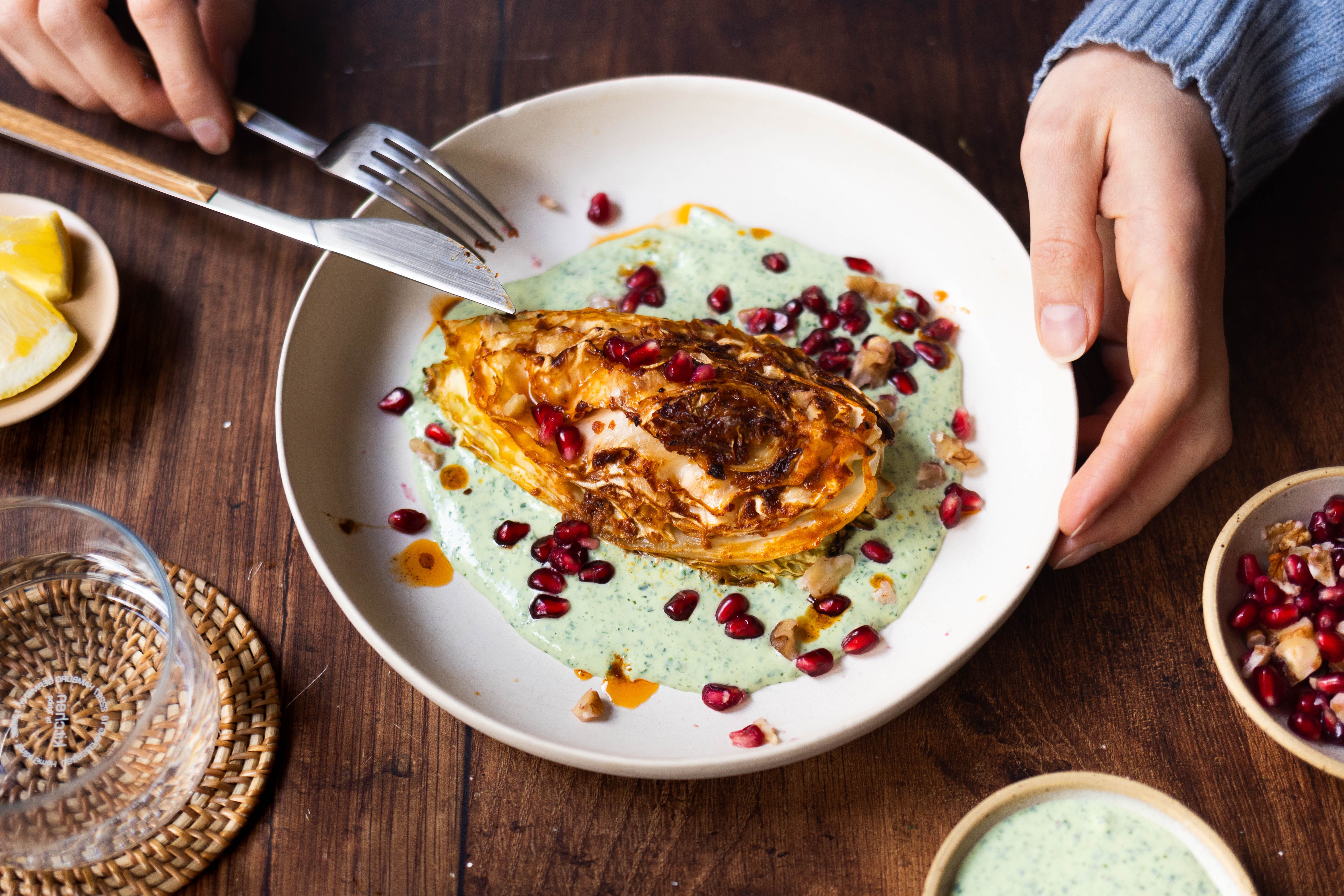 Baked cabbage with herb yogurt and walnut-pomegranate topping